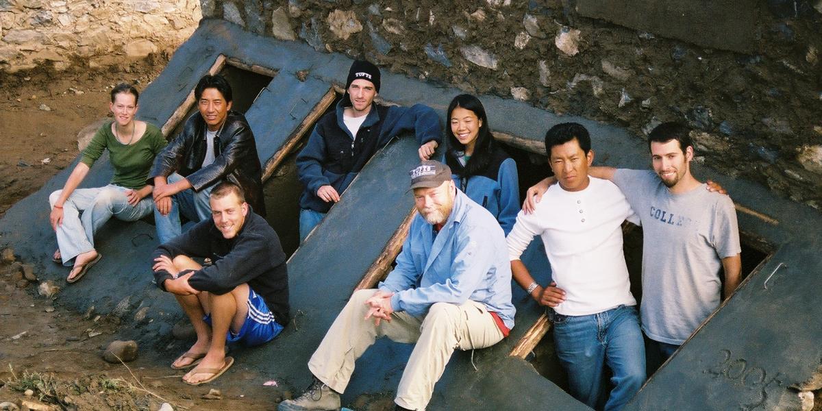 A group of students pose near a self-composting latrine they constructed.