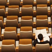 Person sitting alone in a classroom