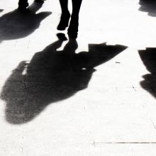 Shadows of three people walking