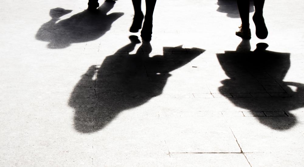 Shadows of three people walking