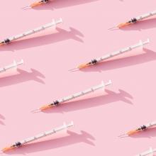 syringes on a pink background