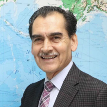 Fernando Torres de la Torre standing in front of a map